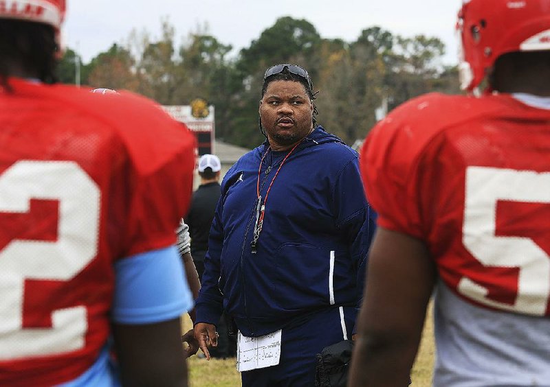 Little Rock McClellan Coach Maurice Moody (center) has the Lions one game away from playing for a Class 5A state championship in just his third season at the school.