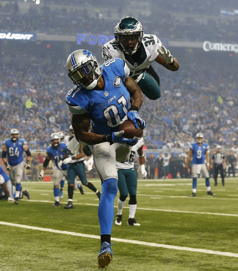 Detroit wide receiver Calvin Johnson (81) scores a second-quarter touchdown in the Lions’ 45-14 victory over Philadelphia on Thursday despite the efforts of the Eagles’ Eric Rowe (32).
