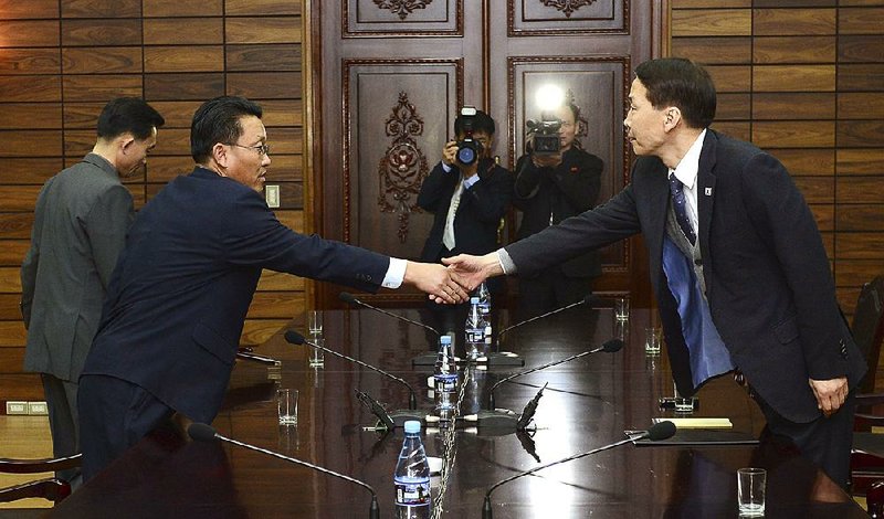 South Korea’s chief delegate Kim Kiwoong (right) greets his North Korean counterpart Hwang Chol during a meeting Thursday in Panmunjom, a border village between the two Koreas. 