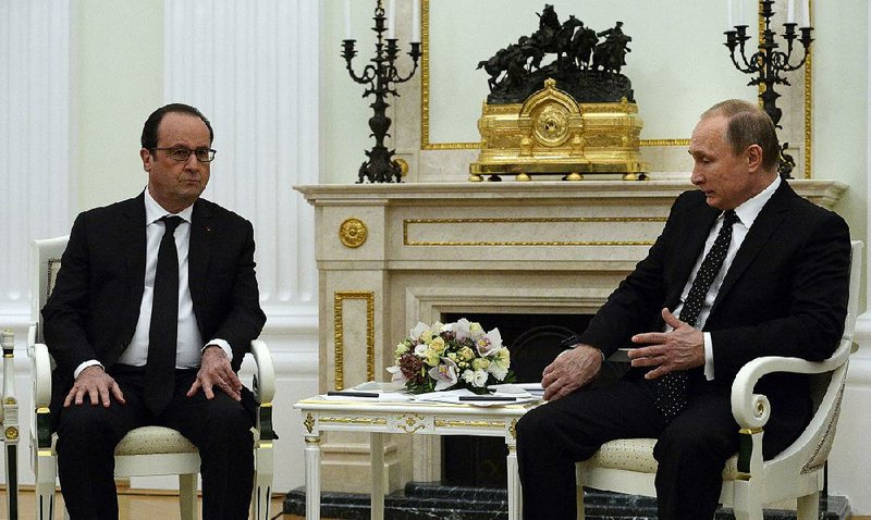 Russian President Vladimir Putin (right) and French President Francois Hollande meet in the Kremlin on Thursday in Moscow. 