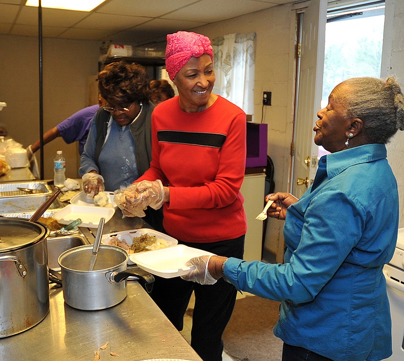 The Sentinel-Record/Mara Kuhn Ollie Naquin, left, Margie Reed and Dorothy Benson prepared dinners at Woodridge Church on Wednesday. The church planned to serve about 150 Thanksgiving dinners for those who were hungry or wanting a holiday meal, and delivered meals to those who are homebound.
