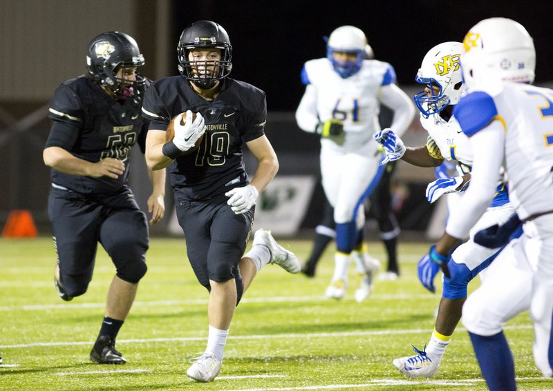 Jacob Clark of Bentonville runs the ball Nov. 20 against North Little Rock at Tiger Stadium in Bentonville.