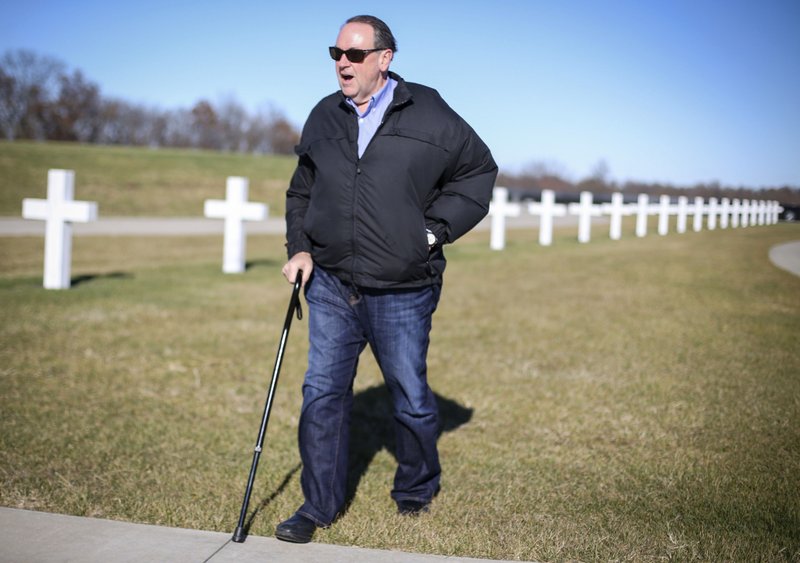 In this Nov. 19, 2015 photo, Republican presidential hopeful former Arkansas governor Mike Huckabee visits the Welcome Home Soldier Memorial in Albia, Iowa.