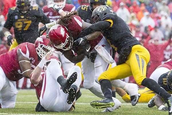 Arkansas running back Alex Collins plunges into the end zone for a score on Friday, Nov. 27, 2015, during the first quarter against Missouri at Donald W. Reynolds Razorback Stadium in Fayetteville.