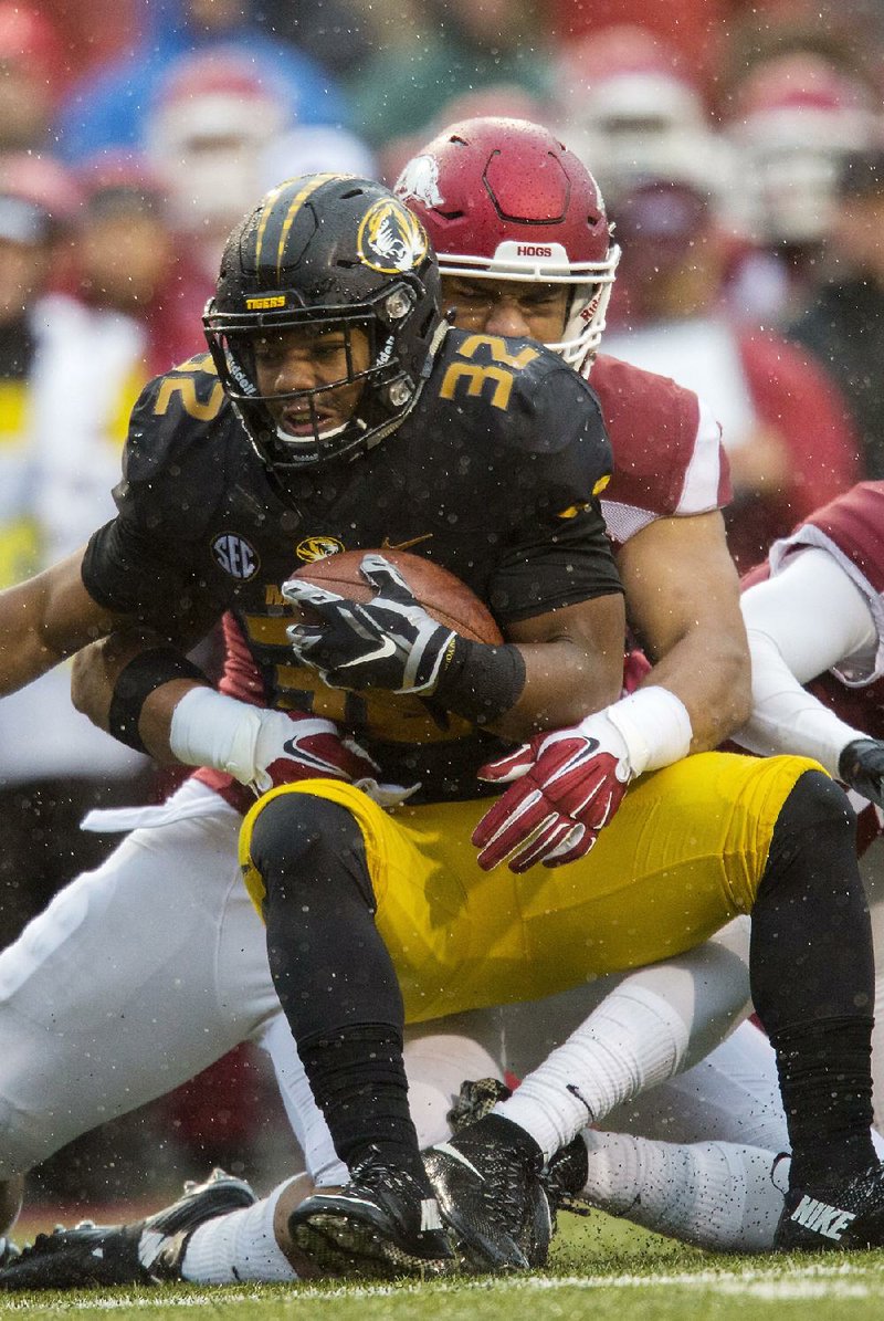 Arkansas had Missouri running back Russell Hansbrough and the Tigers wrapped up from the start, holding Missouri to 24 yards in the first quarter.