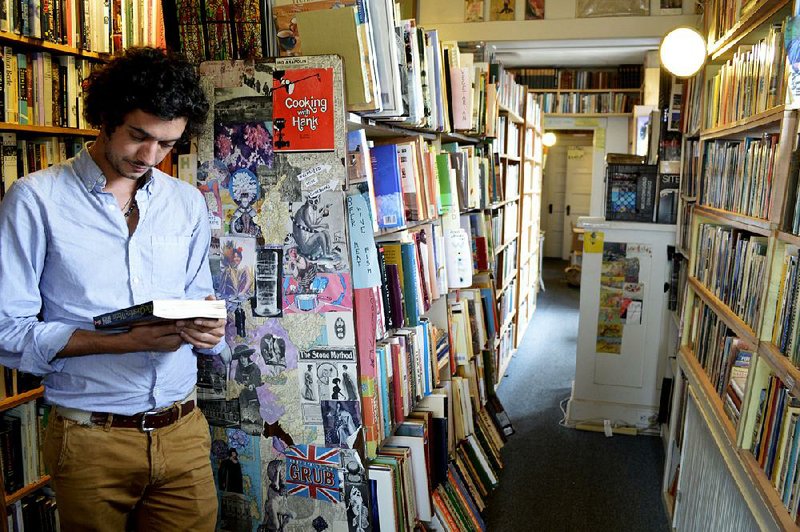 Marco P. Cremasco, 28, of Sao Paulo, Brazil, browses through Downtown Books, located on the iconic Route 66 in Albuquerque, N.M.
