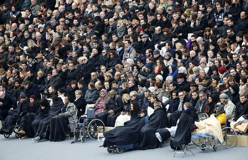 Some of the people wounded in the Nov. 13 Paris attacks attend a somber ceremony Friday at Les Invalides national monument that honored the victims of the attacks.
