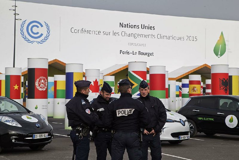 With security tight, police officers gather Friday outside the venue in Paris where the United Nations Climate Change Conference is to take place.
