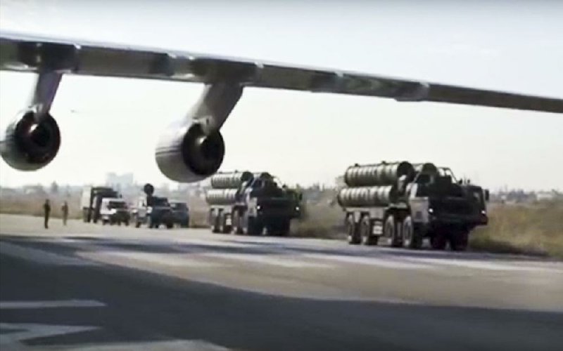 Russian military trucks carry long-range S-400 air-defense missile systems along the runway Friday at the Hemeimeem air base in Syria, about 30 miles south of the Turkish border.