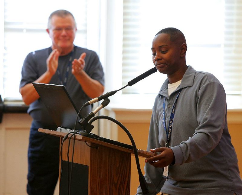 As her supervisor, Mike Bunting, applauds Nov. 20, Police Department employee LaShawn Malone speaks to the Capital City Crime Prevention Task Force about her second chance. “All I needed was this one opportunity,” she said.