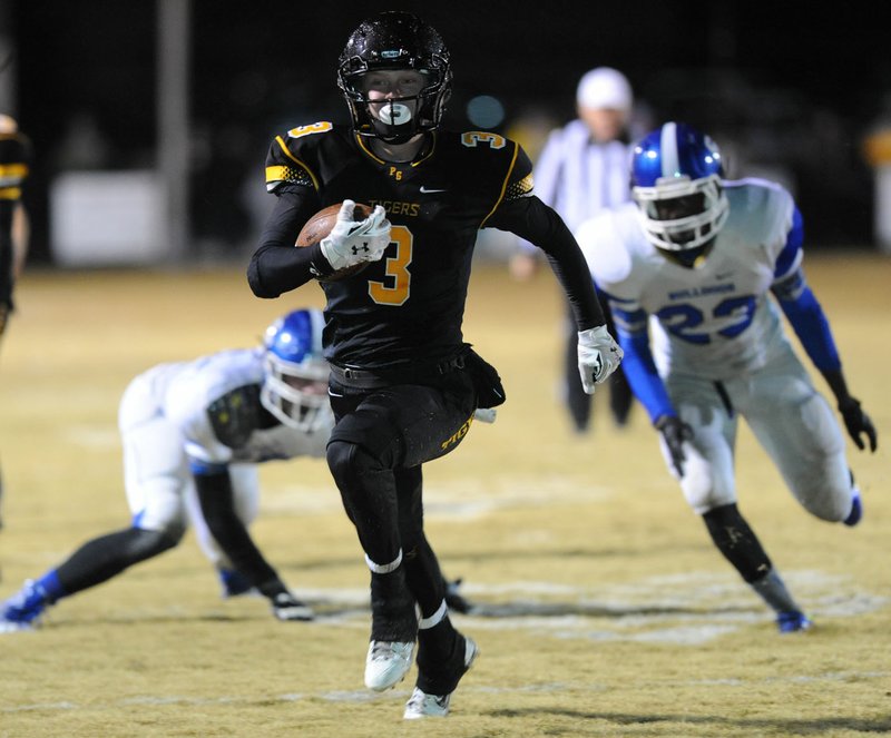 Gavin Heltemes (3) of Prairie Grove carries the ball into the end zone ahead of Ta’marcus Howard (23) of Star City Friday during the first half of play at Tiger Stadium in Prairie Grove. Visit nwadg.com/photos to see more photographs from the game.