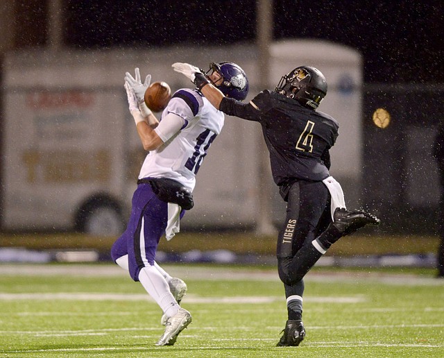 Fayetteville’s Garland Allison hauls in a pass beyond the reach of Bentonville’s Tyrone Mahone for an 80-yard touchdown on the first play from scrimmage during Friday night’s Class 7A semifinal playoff game.