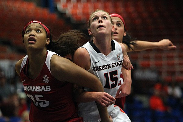 Oregon St. guard Jamie Weisner, center, battle for a rebound against Arkansas’ Tatiyana Smith, left, and Bailey Zimmerman during a NCAA college women's basketball game in Guaynabo, Puerto Rico, Saturday, Nov. 28, 2015. (AP Photo/Ricardo Arduengo)
