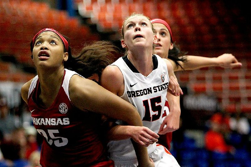 Arkansas center Alecia Cooley (left) and forward Bailey Zimmerman (rear) battle for a rebound against Oregon State guard Jamie Weisner during Saturday’s game in Guaynabo, Puerto Rico. Weisner finished with 26 points to lead No. 7 Oregon State to a 63-47 victory.
