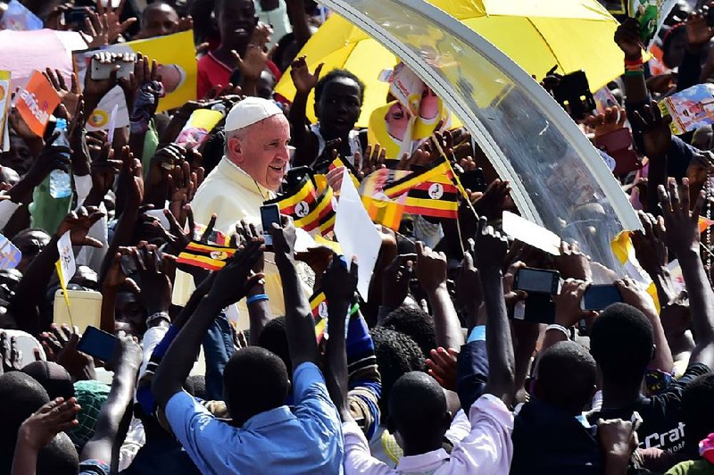 Crowds greet Pope Francis on Saturday at the Kololo airstrip in Kampala, Uganda. He told Ugandans, “In your veins runs the blood of martyrs, and for this reason you have such a strong faith.” 