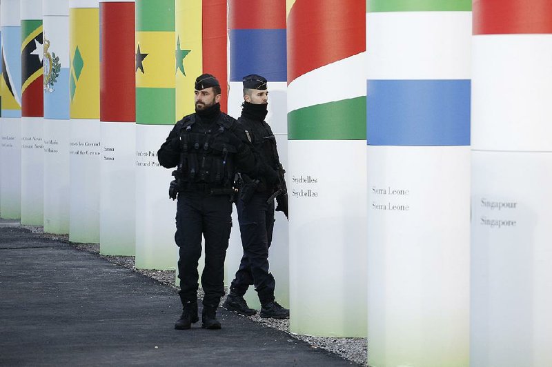 French police officers patrol Saturday outside the main entrance to the United Nations Climate Change Conference site in Le Bourget outside Paris. The area will become U.N. territory during the conference. 