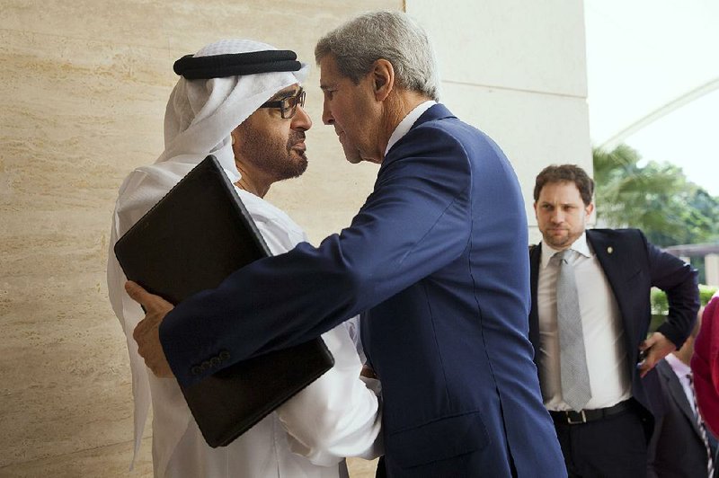 Sheikh Mohammed bin Zayed Al Nahyan greets U.S. Secretary of State John Kerry on Monday at Mina Palace in Abu Dhabi, the United Arab Emirates’ capital. With his nation surrounded by enemies, Mohammed has spent 30 years strengthening its military. 