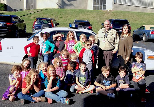 Submitted photo Garland County Sheriff's Department Deputy Matt Cogburn spoke to Nichole Hutzel's second-grade class as part of their "Community Helpers" Social Studies unit. He discussed the role of law enforcement officers and what they do every day to help protect citizens and the community. Cogburn is the Mountain Pine School District Resource Officer.