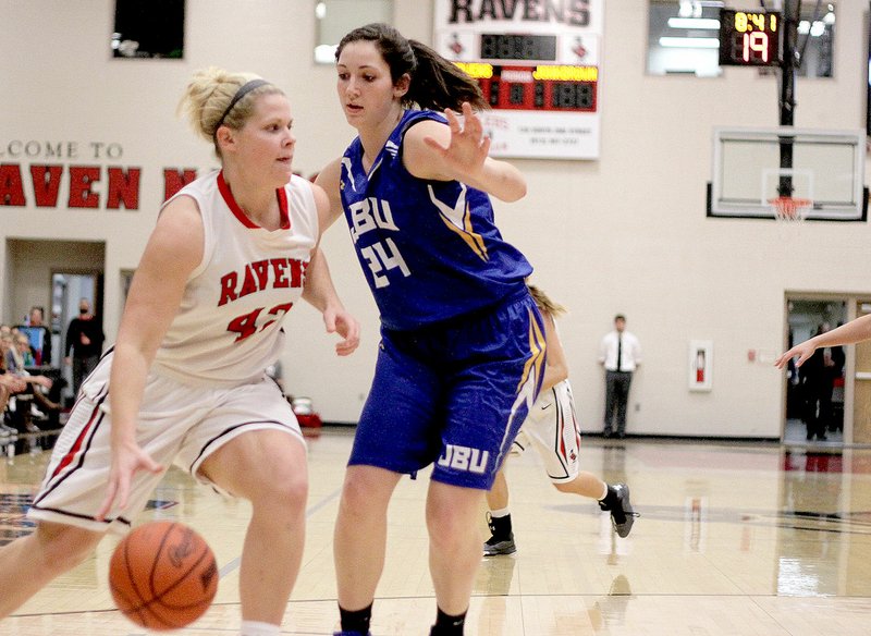 Photo submitted At 5-10, JBU freshman forward Baily Cameron defends a Benedictine player&#8217;s drive during Tuesday&#8217;s game in Atchison, Kan.Cameron, of Siloam Springs, posted some great numbers during the game: career high 24 points, 9 field goals, 6 three-pointers, and 3 blocked shots.