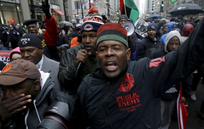 Protesters make their way up North Michigan Avenue on Friday, Nov. 27, 2015, in Chicago. Community activists and labor leaders hold a demonstration billed as a "march for justice" on Black Friday in the wake of the release of video showing an officer fatally shooting Laquan McDonald.