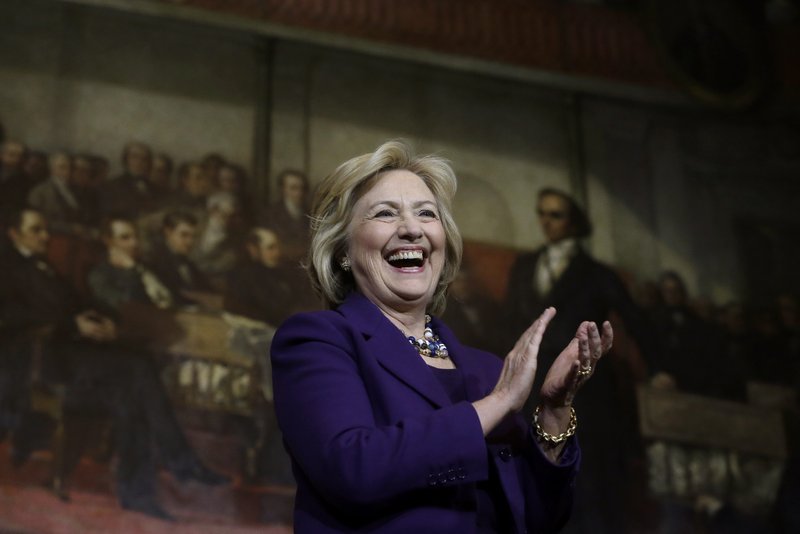 Democratic presidential candidate Hillary Clinton smiles on stage at the start of a rally, Sunday, Nov. 29, 2015, in Boston. Clinton and Boston Mayor Marty Walsh attended the event to launch "Hard Hats for Hillary," a coalition to organize working families in construction, building, transportation, and other labor industries to support Clinton's agenda. 