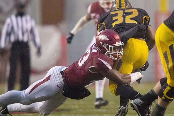 Arkansas linebacker Dre Greenlaw makes a stop on Missouri running back Russell Hansbrough on Friday, Nov. 27, 2015, during the fourth quarter at Donald W. Reynolds Razorback Stadium in Fayetteville.