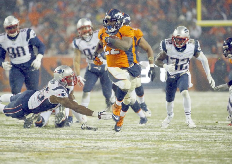 Denver running back C.J. Anderson (22) breaks free from New England linebacker Jonathan Freeney (55) to score the game-winning, 48-yard touchdown in overtime as the Broncos handed the Patriots their first loss of the season with a 30-24 victory.
