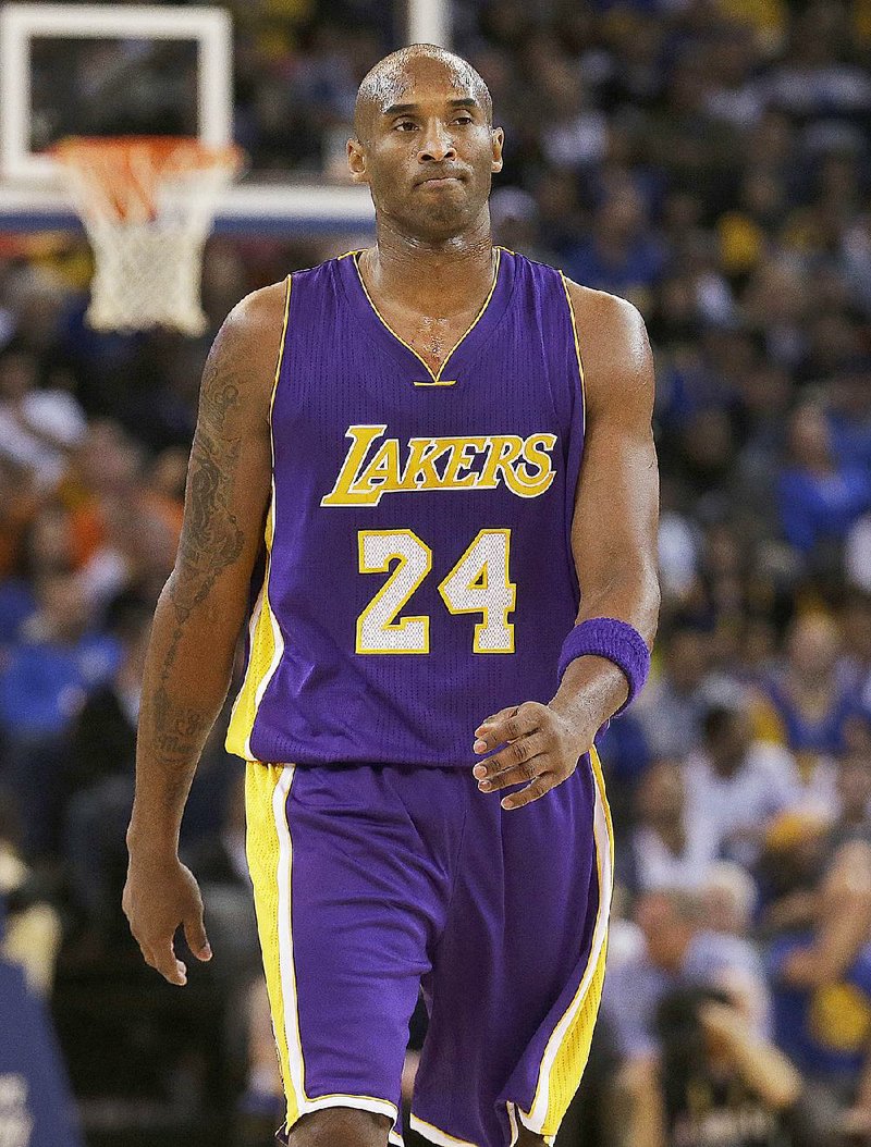 Los Angeles Lakers guard Kobe Bryant (24) walks on the floor during the second half of an NBA basketball game against the Golden State Warriors in Oakland, Calif., Tuesday, Nov. 24, 2015.  
