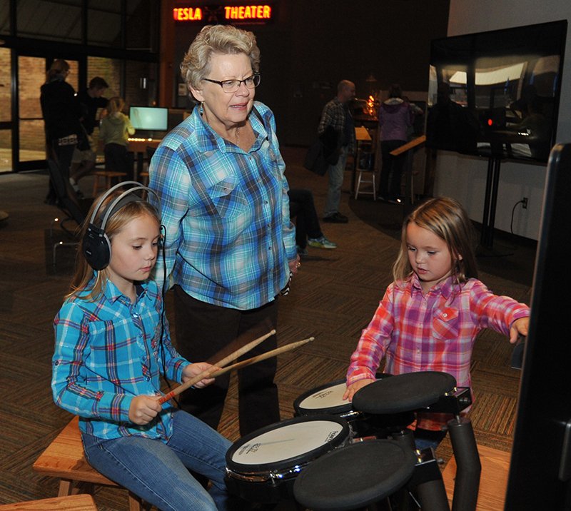 The Sentinel-Record/Mara Kuhn From left, Haylie Wallace, 8, of Piperton, Tenn., and her grandmother, Jo Beth Rush, of Collierville, Tenn., and sister, Henslie Wallace, 5, of Piperton, play on exhibits Saturday at Mid-America Science Museum.