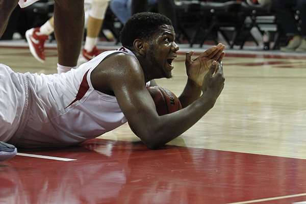 Arkansas' Trey Thompson (1) calls time out from the floor after wrestling the ball away during the second half of an NCAA college basketball game against Akron, Wednesday, Nov. 18, 2015, in Fayetteville, Ark. Akron defeated Arkansas, 88-80. (AP Photo/Samantha Baker)