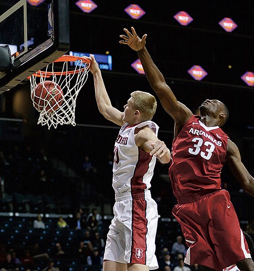 The Associated Press SMALL ON HEIGHT: Stanford's Michael Humphrey (10) drives past Arkansas's Moses Kingsley (33) for a dunk during the second half of an NIT Season Tip-Off consolation game Friday in New York. Kingsley doesn't have much backing him up on the block for tonight's game against Northwestern State at Walton Arena after Trey Thompson went down with an ankle injury Thursday against Georgia Tech.