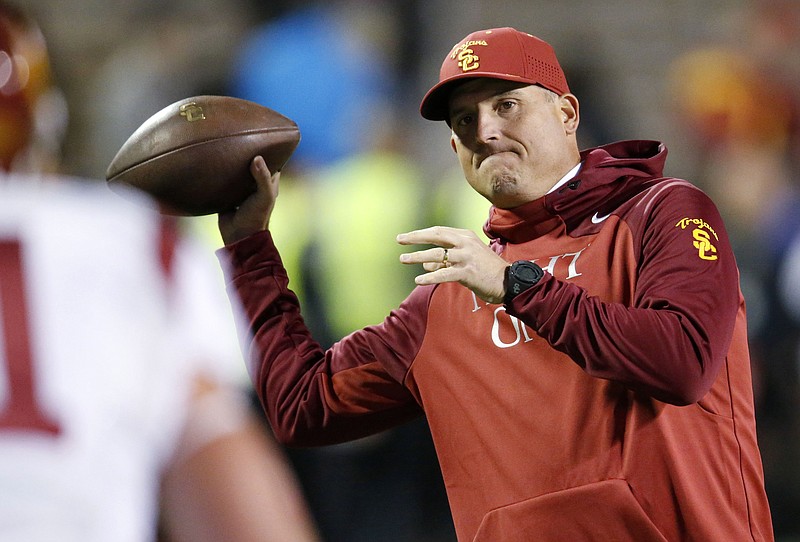 The Associated Press HARDENED CLAY: Southern California interim coach Clay Helton throws a football during the first half of a game against Colorado Nov. 13 in Boulder, Colo. USC hired Helton as its permanent coach Monday, removing the interim tag after he guided the Trojans to a division title since taking over for fired Steve Sarkisian.