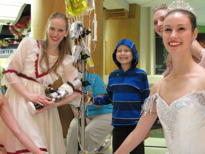 Arkansas Children's Hospital patient Jacques Crochet, 7, of Little Rock stands with dancers from Ballet Arkansas after a performance of "The Nutcracker" in the hospital's rotunda Tuesday, Dec. 1, 2015.