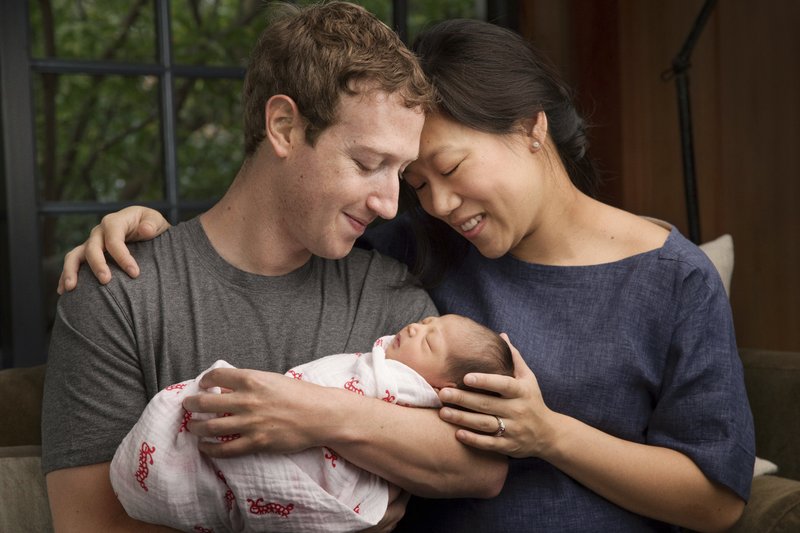 In this undated photo provided by Mark Zuckerberg, Max Chan Zuckerberg is held by her parents, Mark Zuckerberg and Priscilla Chan Zuckerberg. 