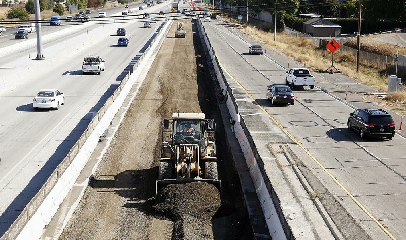 Contractors work on new lanes for Interstate 80 in Sacramento, Calif., in October. Congress has reached a deal to increase funding for roads and transit systems. 