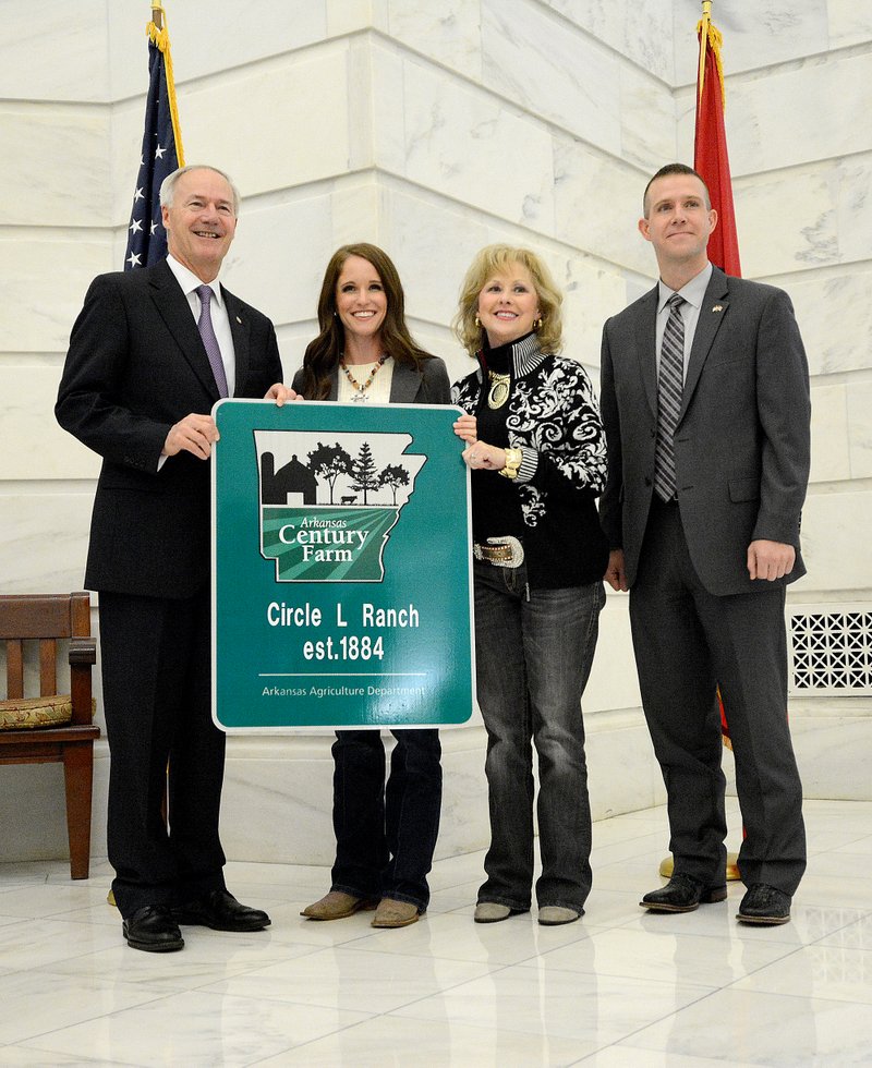 Submitted Photo Governor Asa Hutchinson presented the Leonard family with a Century Farm sign at the state capitol. Pictured are Gov. Asa Hutchinson, Amanda (Leonard) Price, Tricia Leonard and Arkansas Agriculture secretary Wes Ward.