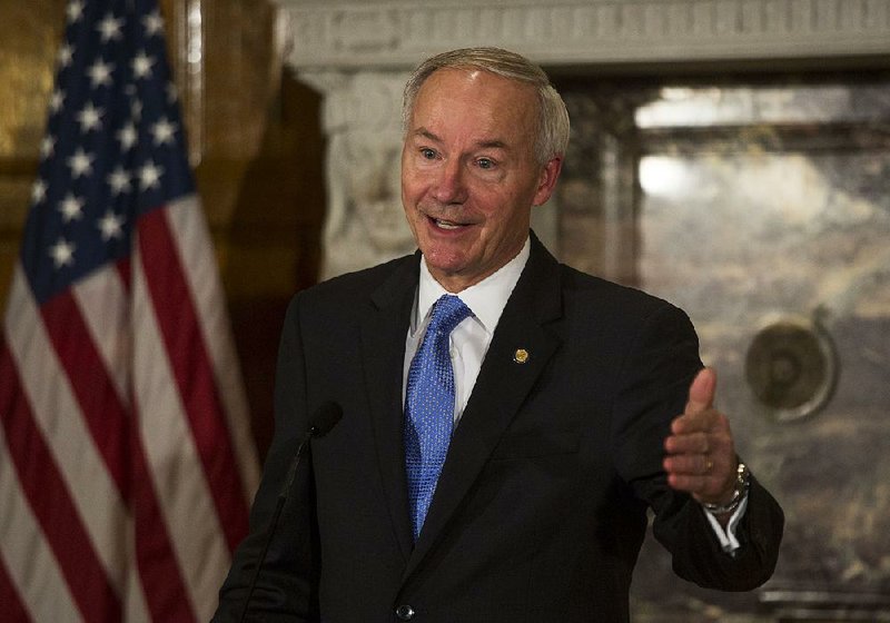 Gov. Asa Hutchinson answers questions regarding an announcement of a trade mission to Japan and China during a press conference at the State Capital November 6, 2015. 