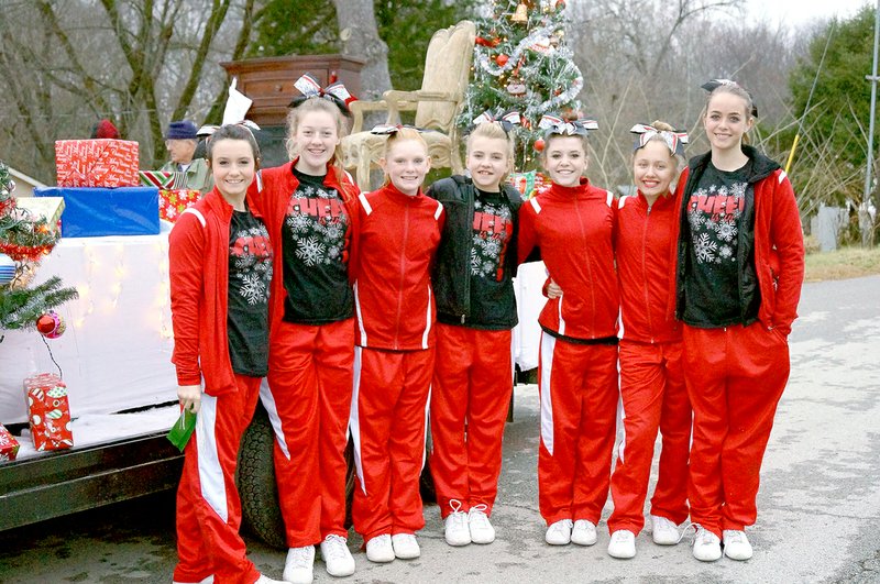 Photos by RITA GREENE MCDONALD COUNTY PRESS McDonald County junior high cheerleaders try to stay warm while participating in the 2014 Pineville Christmas Parade.