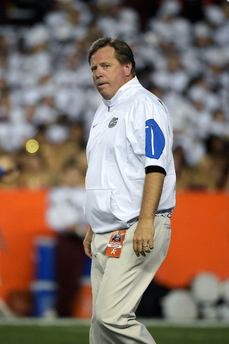 Florida head coach Jim McElwain watches warmups before an NCAA college football game against Florida State in Gainesville, Fla., Saturday, Nov. 28, 2015. 