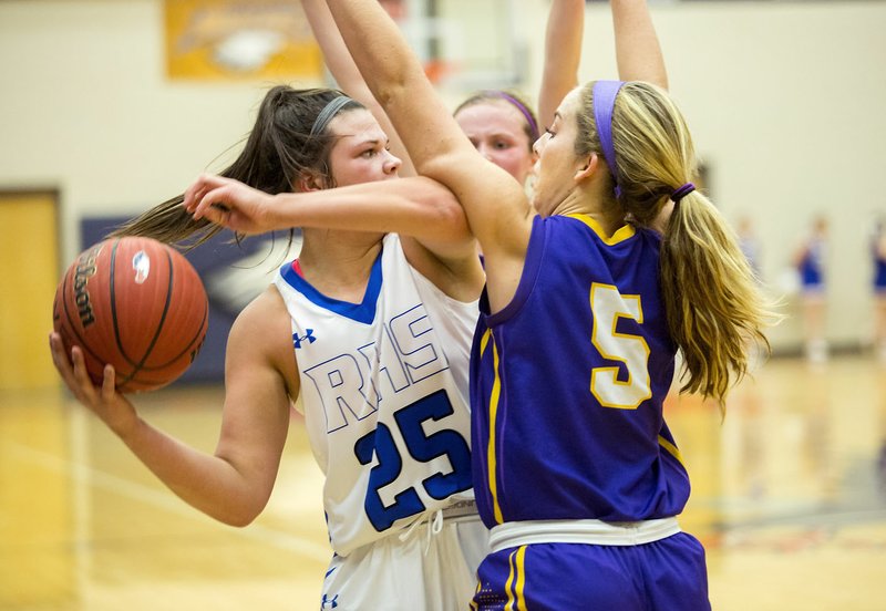 NWA Democrat-Gazette/JASON IVESTER Rogers junior Madison Sandor looks to pass around the defense from Camdenton (Mo.) senior Sophie Shore during the first half on Thursday, Dec. 3, 2015, during the Great 8 Classic at Rogers Heritage High School.