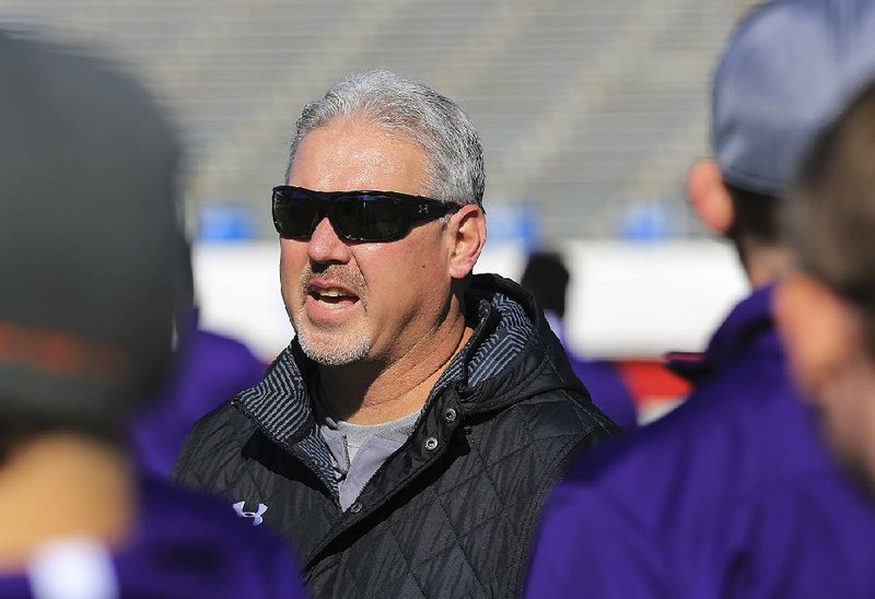  Fayetteville football coach Daryl Patton talks to his team Friday, Dec. 4, 2015, during a practice at War Memorial Stadium. 