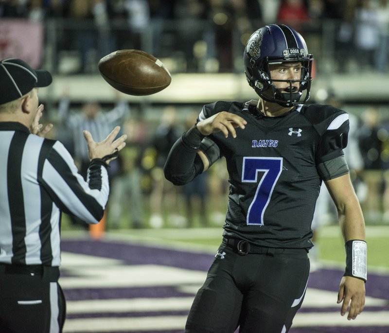 Taylor Powell, Fayetteville quarterback, tosses the ball back to a referee Nov. 6 at Harmon Play Field in Fayetteville. The Bulldogs will open their football season at home Sept. 2 against Blue Springs (Mo.) North.