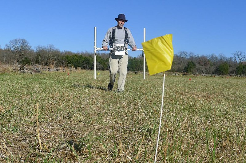 Jami Lockhart, director of remote sensing for the Arkansas Archeological Survey, uses a gradiometer to look for artifacts Thursday at Ruddick’s field at Pea Ridge National Military Park. 