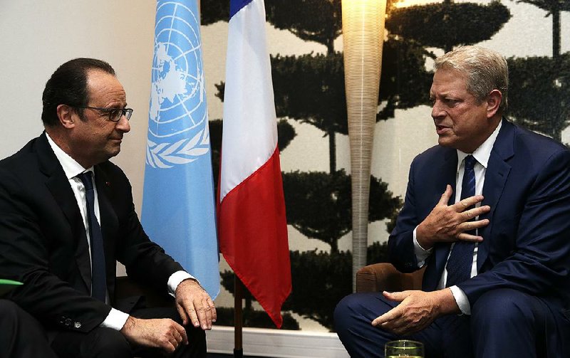 French President Francois Hollande and former U.S. Vice President Al Gore attend an “Action Day” event Saturday in Paris. Gore likened the effort on climate change to the struggles to end slavery and apartheid.