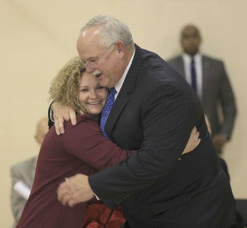 Stuttgart High School teacher Meghan Ables hugs Superintendent Nathan Gills after she was named the state’s Teacher of the Year on Monday.