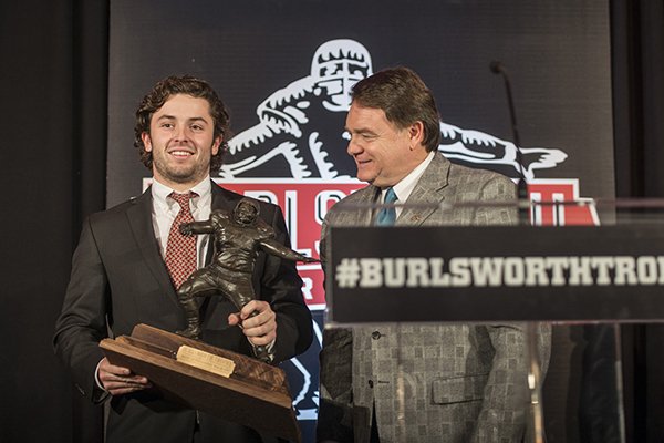Baker Mayfield, Oklahoma University quarterback, accepts the Burlsworth Trophy from Houston Nutt, former head football coach for the University of Arkansas, Monday, Dec. 7, 2015, at the awards ceremony at the Springdale Convention Center. The award recognizes former walk-on players.