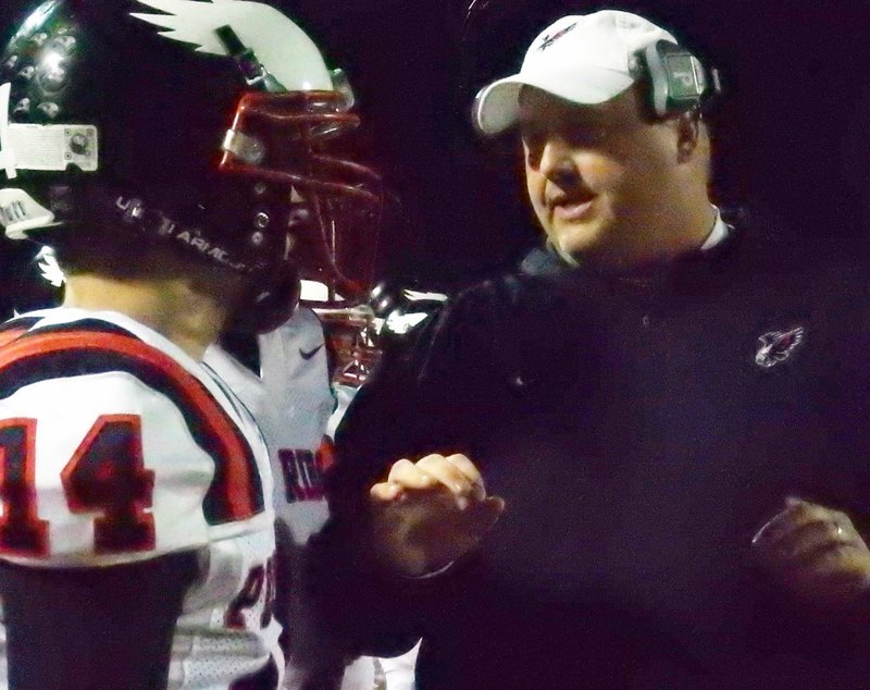 TIMES photograph by Annette Beard Blackhawk head football coach Tony Travis talks to quarterback Jakota Sainsbury on the sidelines during the state semi-final 4A game in Nashville. Travis was named coach of the year by the Arkansas Farm Bureau.