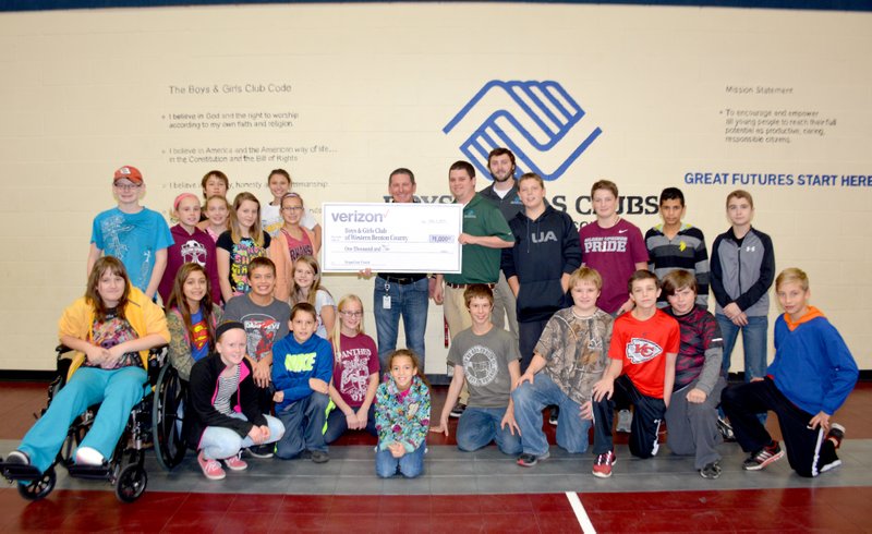 Janelle Jessen/Herald-Leader J.P. Marquis, solutions manager for Verizon Wireless of Siloam Springs, presented a $1,000 donation to Boys and Girls Club of Western Benton County on Tuesday afternoon. The donation was part of the #GivingTuesday campaign.