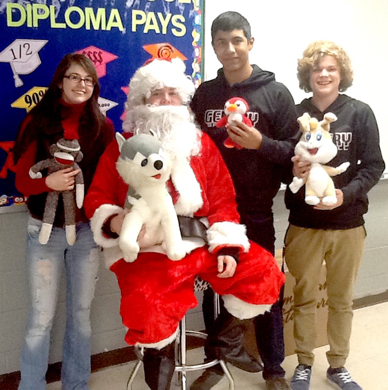Submitted Photo Gentry High School students Elaine McGinnis, Carlos Alvarez (as Santa Claus), Del Castillo and Drake Barnes posed for a photo to help promote the Toy Toss event for the Northwest Arkansas Children&#8217;s Shelter.