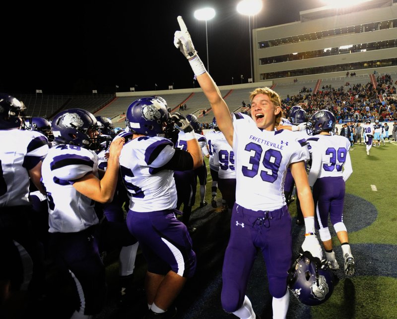 Fayetteville players celebrate their 28-7 win over Har-Ber Saturday, Dec. 5, 2015, the Class 7A state championship game at War Memorial Stadium in Little Rock. Despite several large college and high school stadiums in the state, all championship games are played at the same site each year.